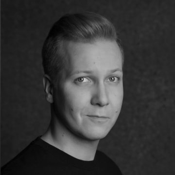 Mustavalkoinen muotokuva nuoresta henkilöstä, jolla on lyhyet vaaleat hiukset ja joka katsoo suoraan kameraan neutraalilla ilmeellä. Tausta on yksivärinen ja tumma, ja henkilöllä on yllään tumma paita.